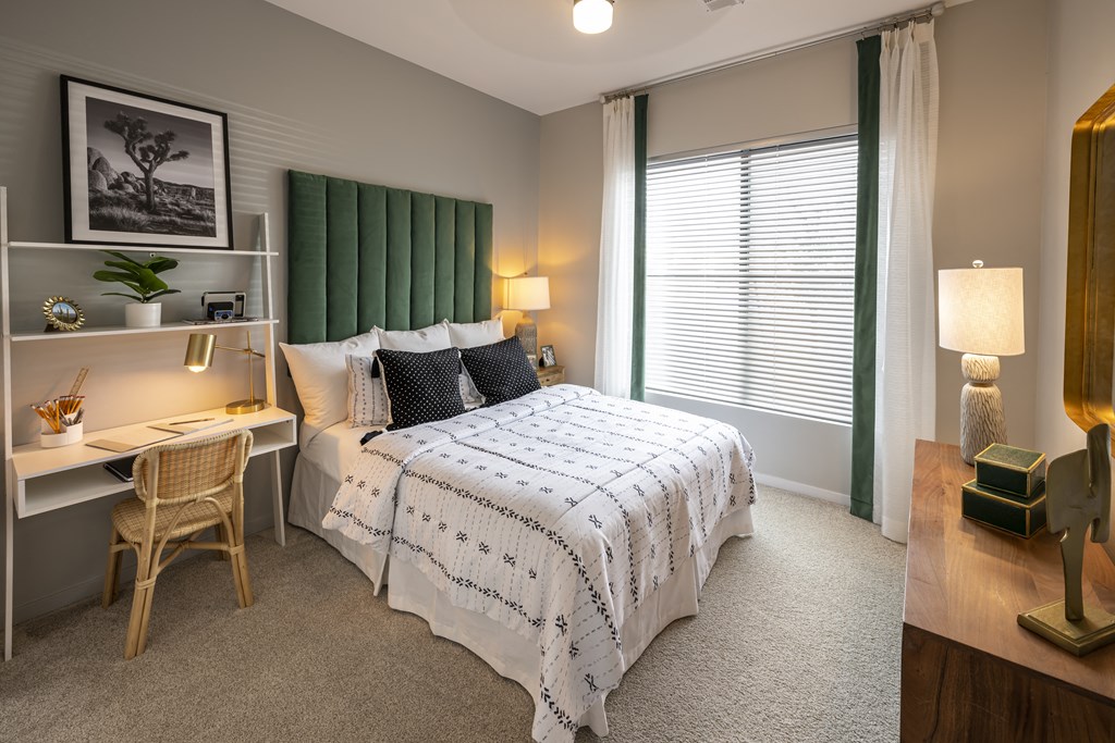 Icon at Cooley Station-apartment bedroom with a bed and a desk and a window