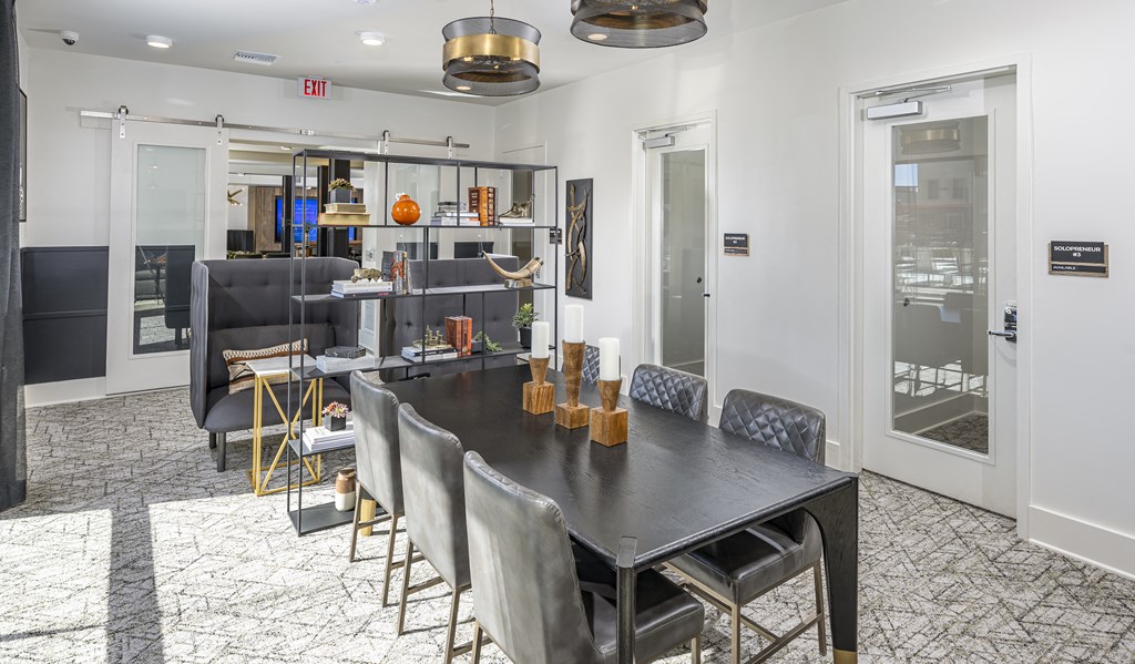 Icon at Cooley Station-Clubhouse with large table black table and chairs and a kitchen for events