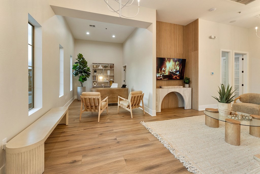 a living room with a fireplace and a table and chairs