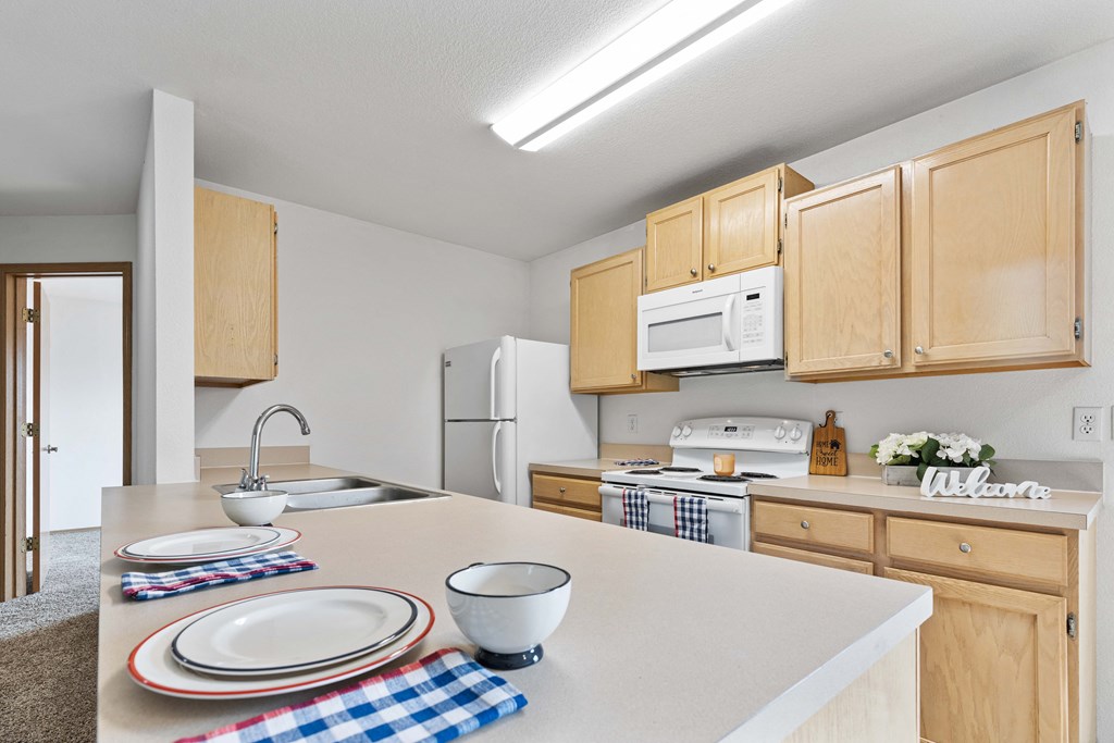 a kitchen with wooden cabinets and white appliances