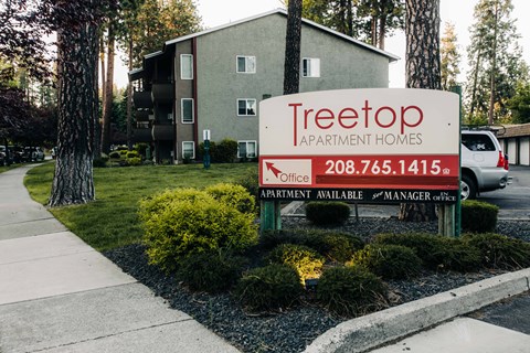 a sign in front of an apartment building