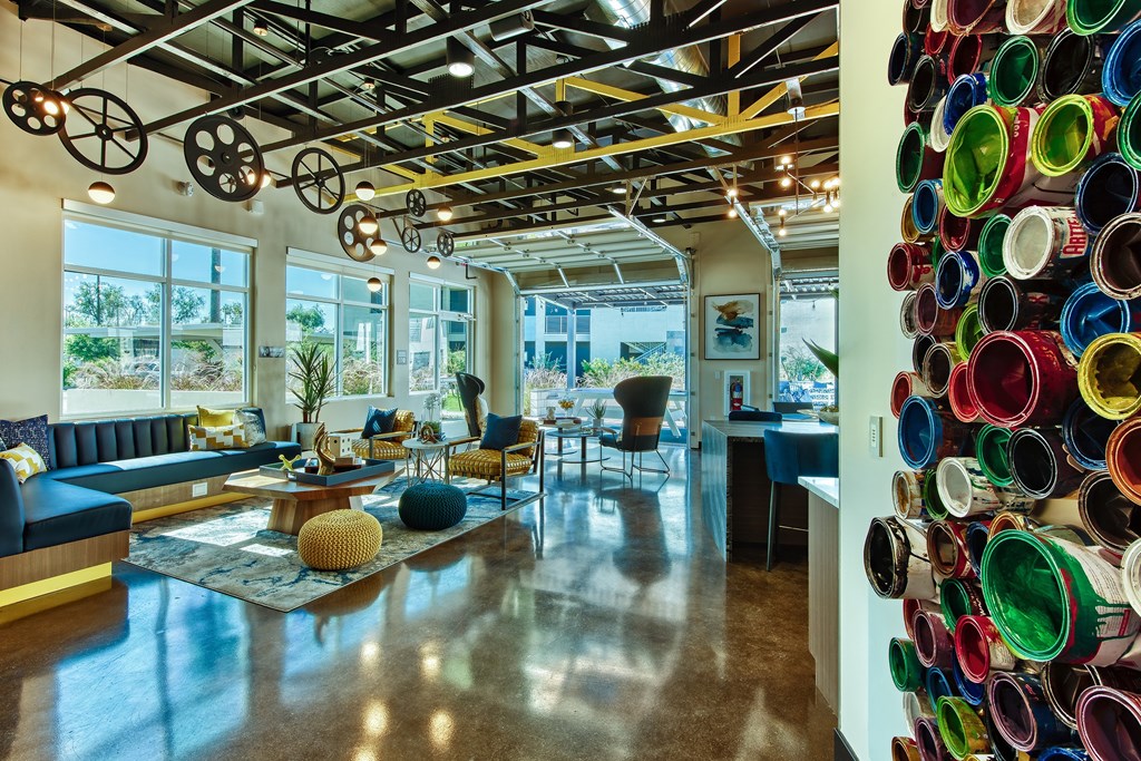 A room with a large window and a wall of colorful cups.