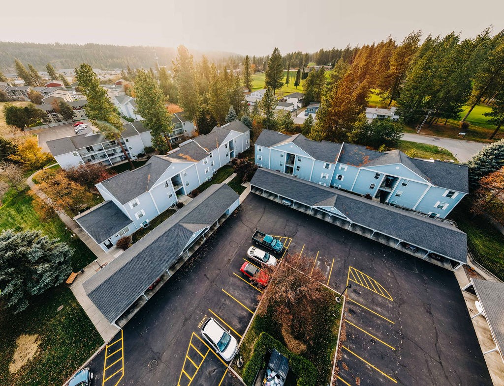 an aerial view of a house and a parking lot