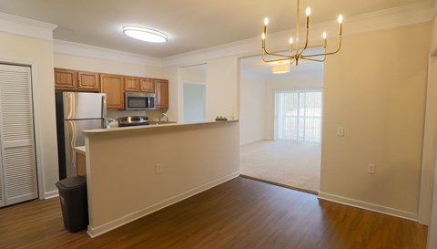 A kitchen with wooden cabinets and a refrigerator.