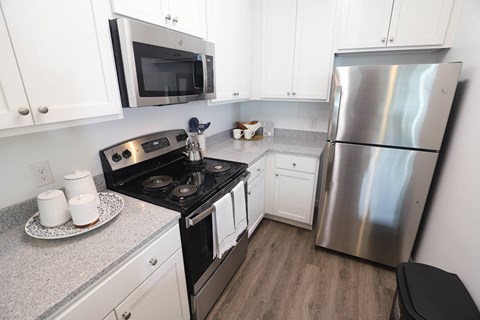 a kitchen with stainless steel appliances and white cabinets