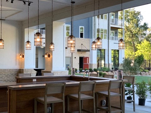 a kitchen with a bar and chairs