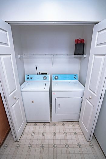 the laundry room has two washers and two dryers
