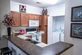a kitchen with a granite counter top and white appliances