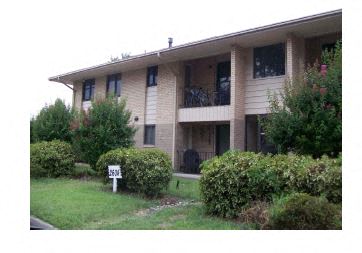 a house with a yard and a sign in front of it