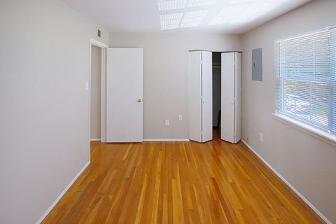 A room with wooden floors and white walls.