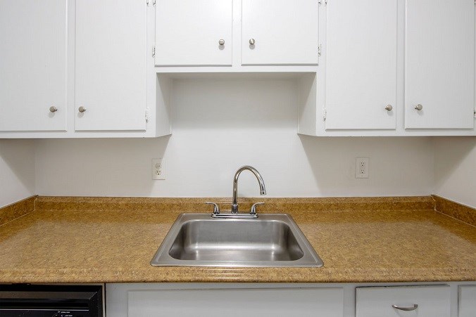 A kitchen with a sink and cabinets.