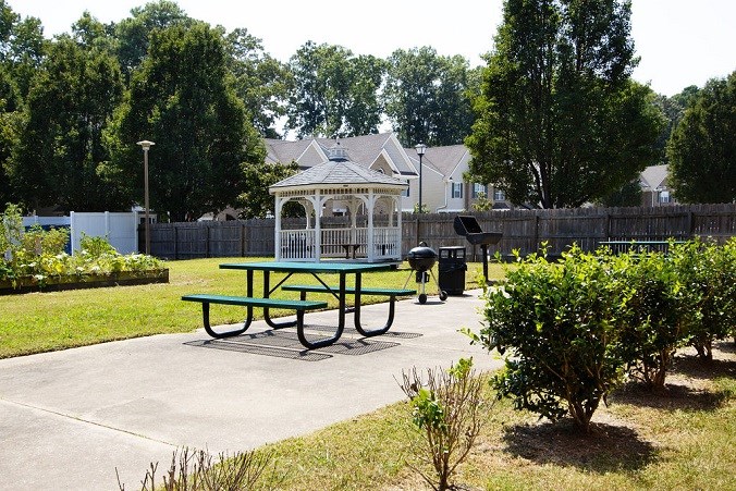 A picnic table sits in the middle of a park.
