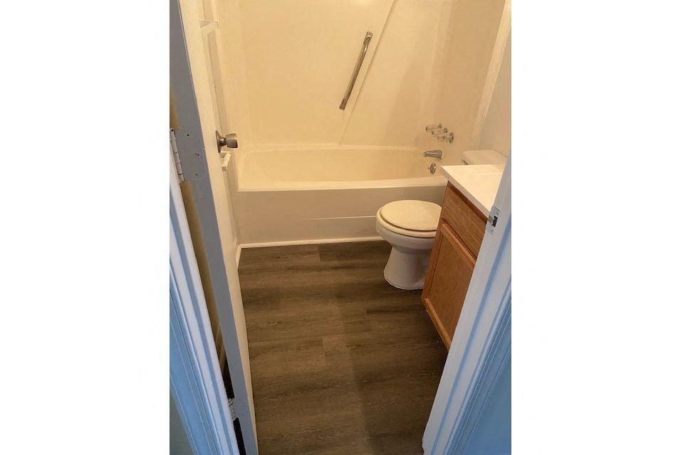a bathroom with a toilet and a bath tub