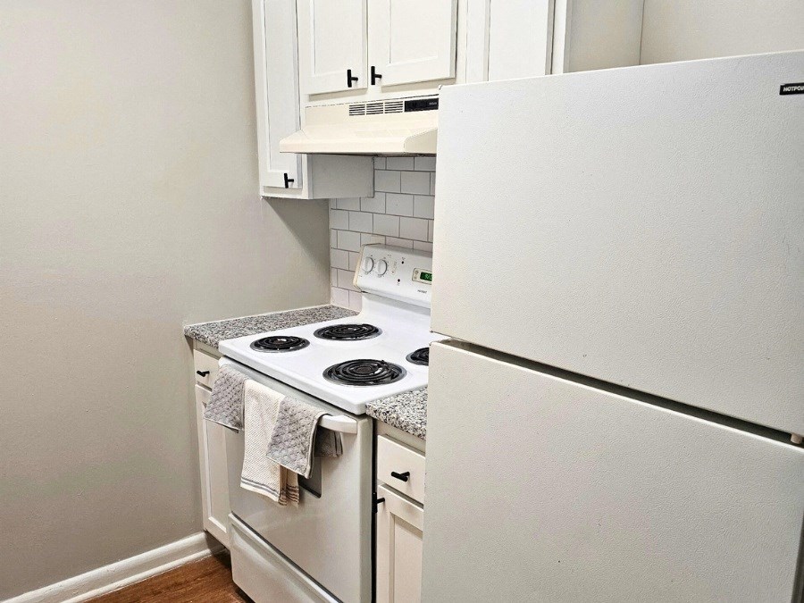 a small kitchen with a stove and a refrigerator