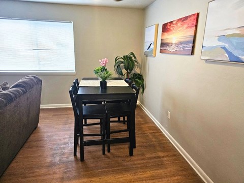 a dining room with a table and chairs and a couch