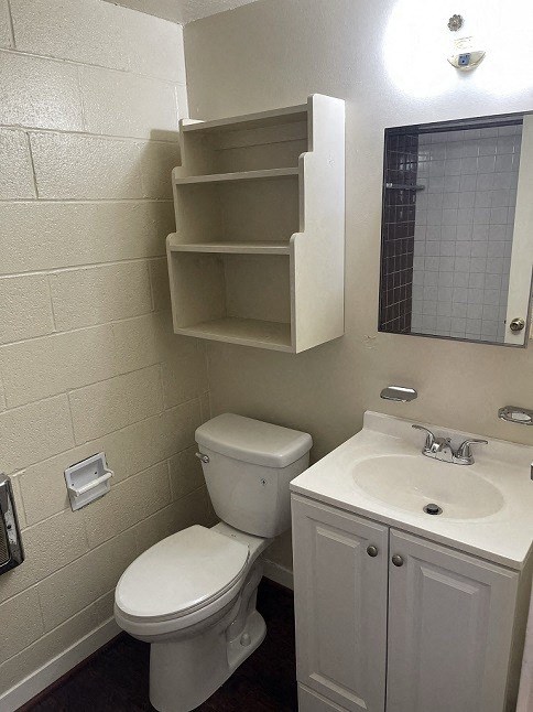 a white bathroom with a toilet and a sink
