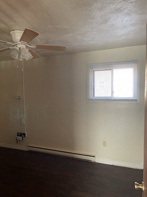 an empty room with a ceiling fan and a window