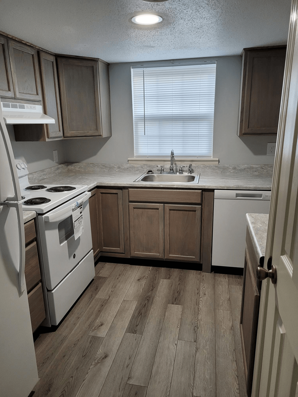 a kitchen with white appliances and wooden cabinets