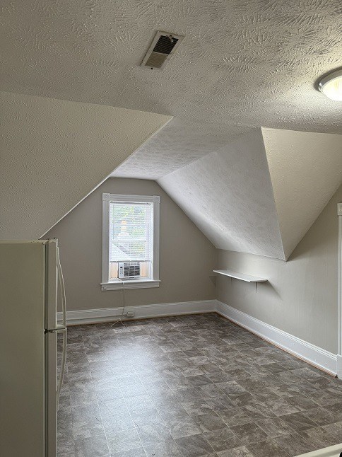 A room with a window and a tiled floor.