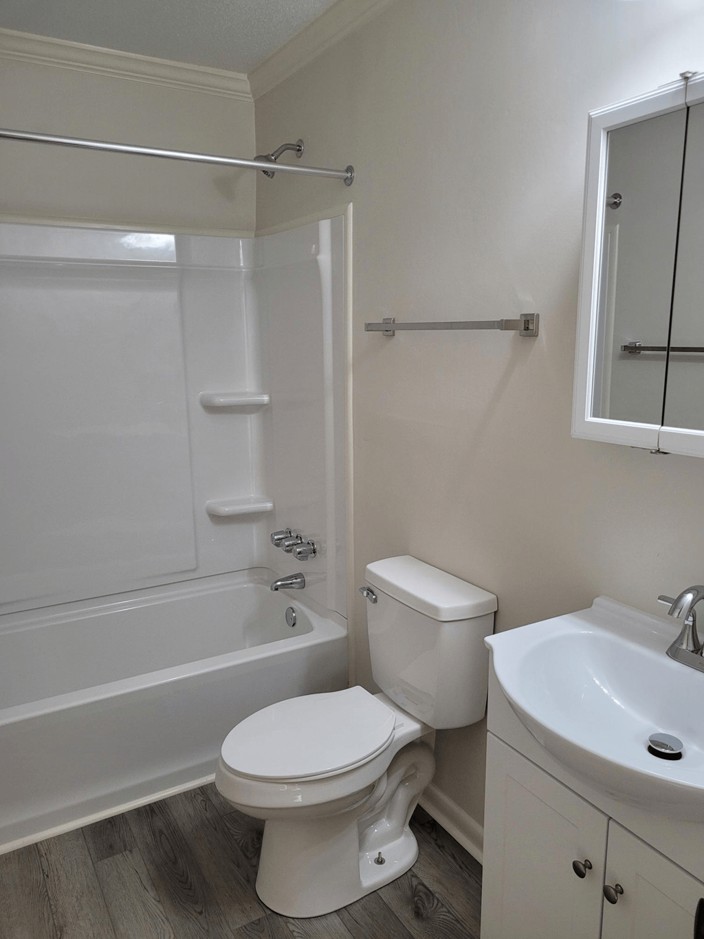 a bathroom with a toilet and a tub and a sink