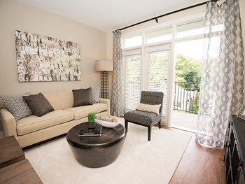 Living Room With Balcony Living Room With Balcony at Link Apartments® Brookstown, Winston Salem - Photo Gallery 4