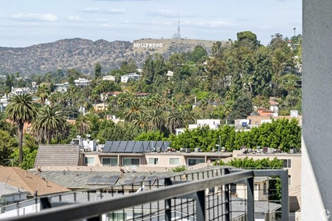A view of a residential area with a Hollywood sign in the distance.
