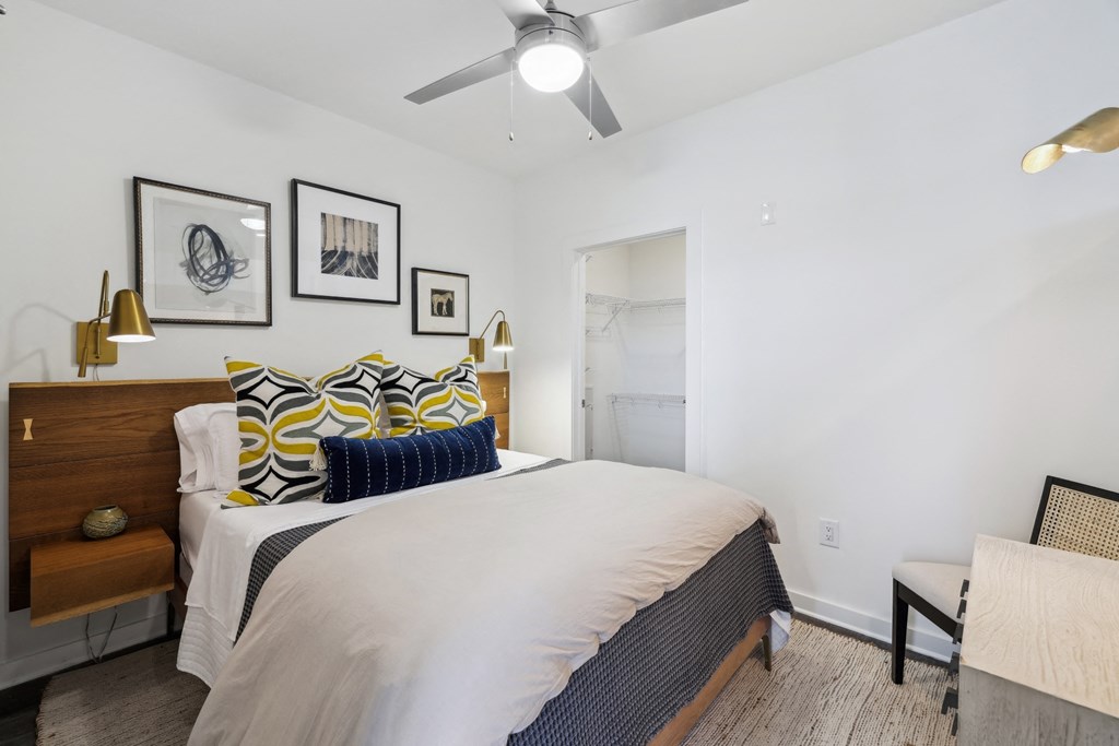 a bedroom with a large bed and a ceiling fan
