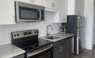 Sparkling Kitchen with Plank Flooring, Efficient Appliances and  Subway Tile Backsplash at Link Apartments® H Street,  Washington DC, 20002 - Photo Gallery 5
