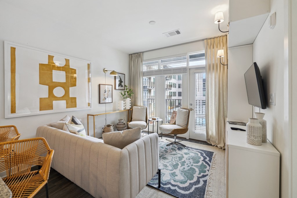 a living room with a white couch and a large window