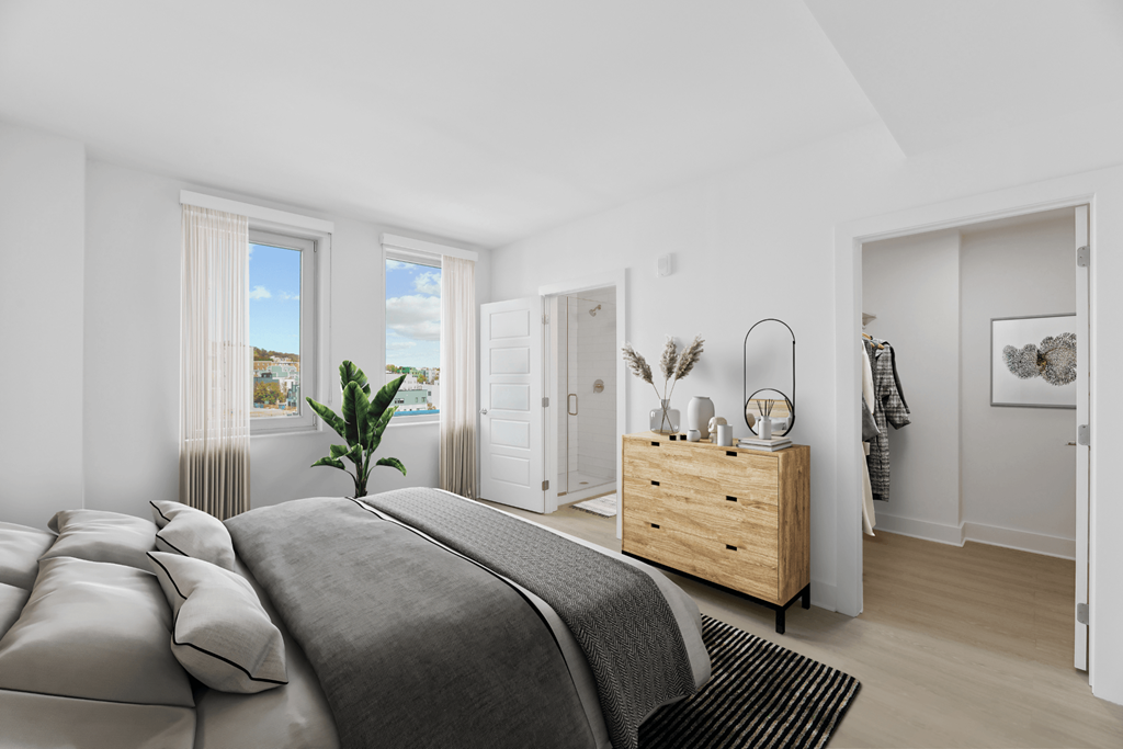 a bedroom with a bed and a dresser  at Link Apartments® H Street, Washington, 20002