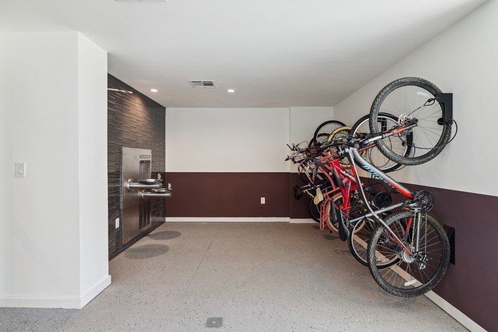 a group of bikes hanging on the wall in a room