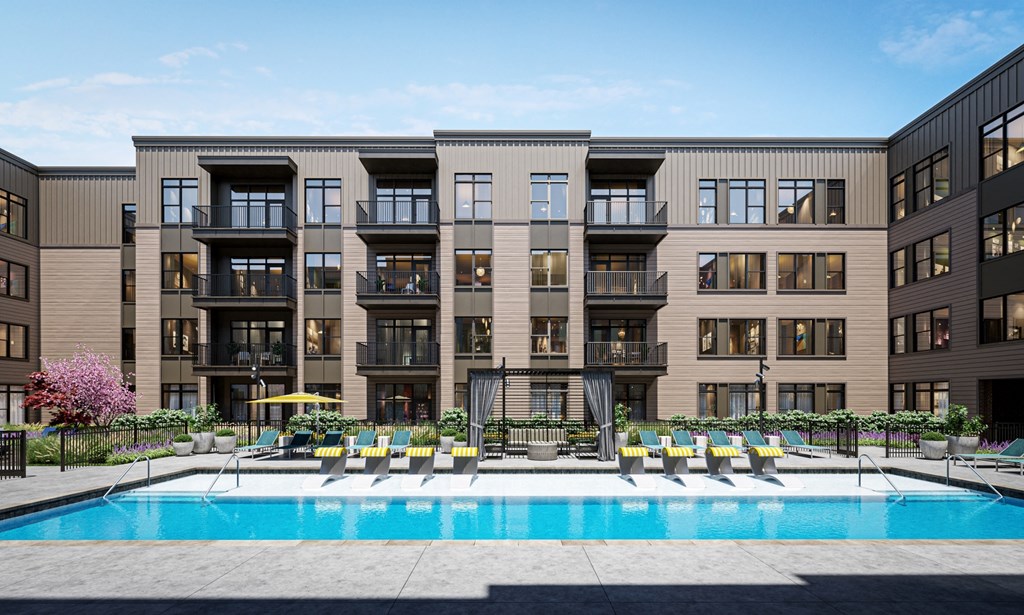 a swimming pool is in front of an apartment building