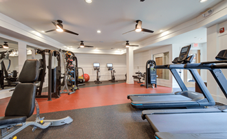 a gym with cardio equipment and weights  at Link Apartments® Brookstown, North Carolina, 27101