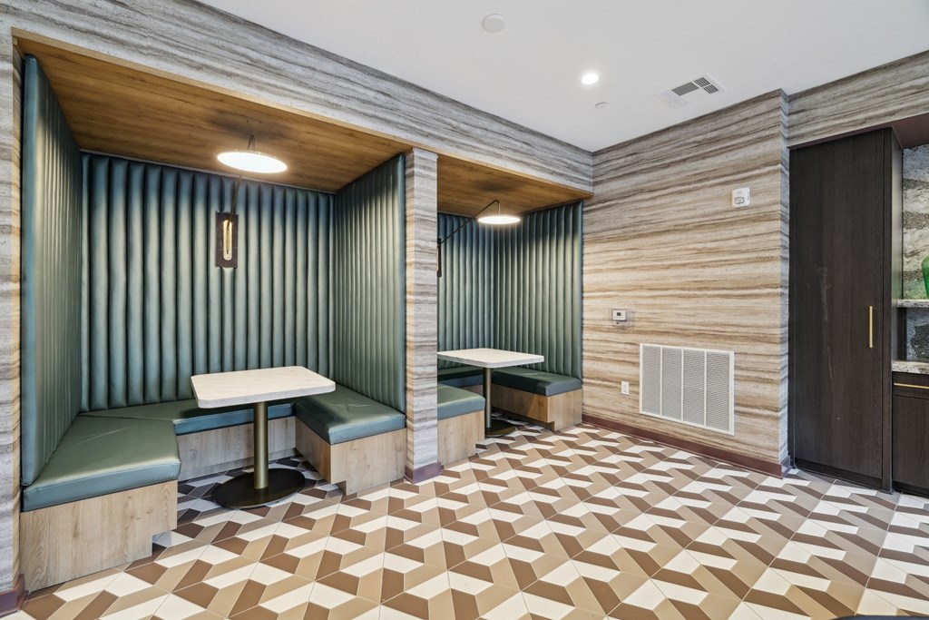 a tasting room with two booths and a wooden floor and green walls
