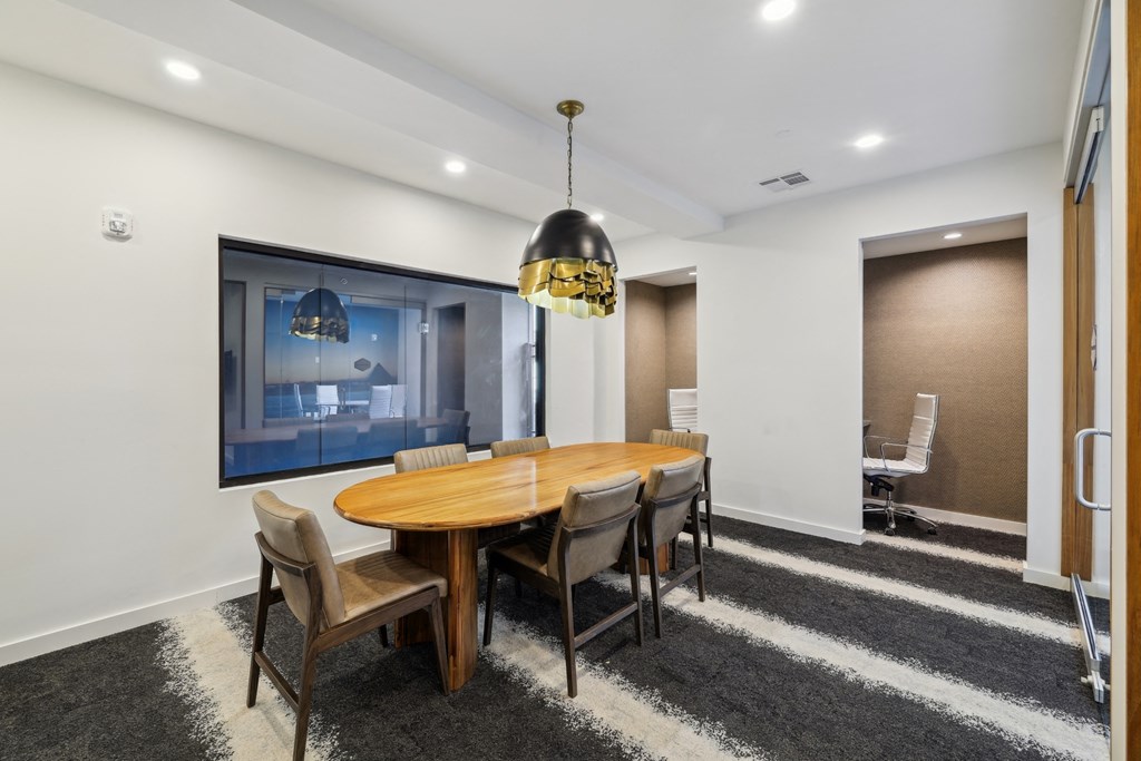 a dining room with a wooden table and chairs