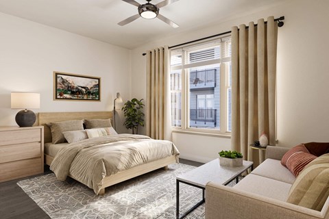 a bedroom with a bed and a ceiling fan at Link Apartments® Calyx, Chapel Hill, 27517