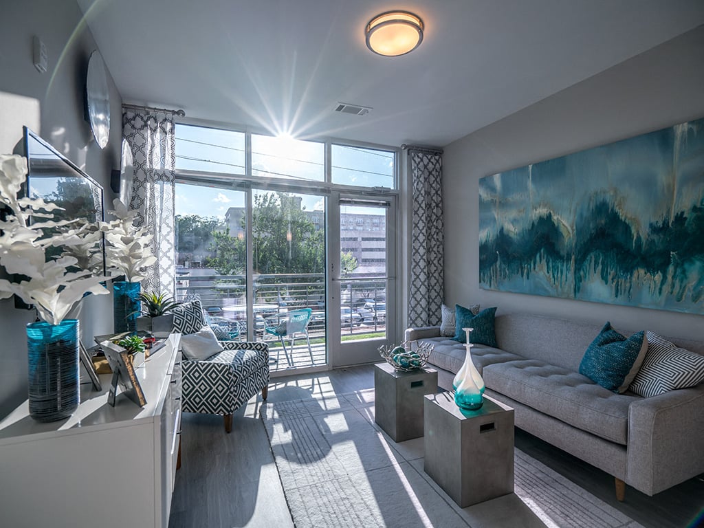 a living room with a large window and a couch