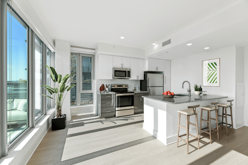 a kitchen with a large island and a large window  at Link Apartments® H Street, Washington