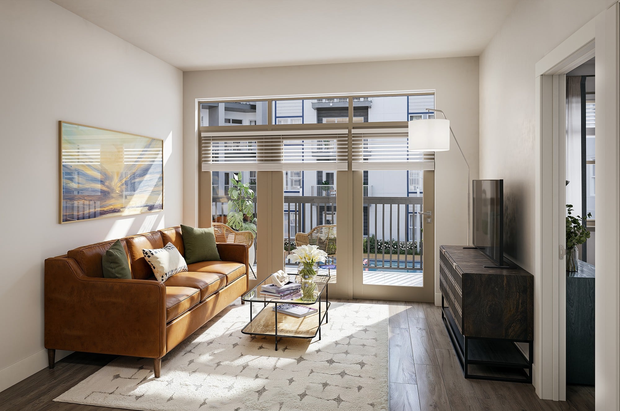 A living room with a brown couch and a painting on the wall.