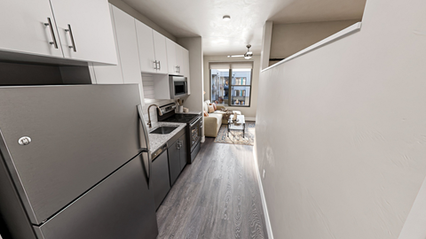 a kitchen and living room in a 555 waverly unit at Link Apartments NoDa 36th, Charlotte, 28206