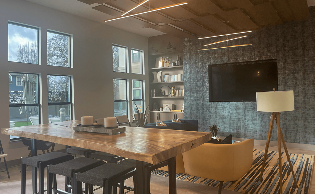 a room with a table and chairs and a flat screen tv on the wall a room with a table and chairs and a flat screen tv on the wall at Link Apartments® Canvas, Atlanta, GA