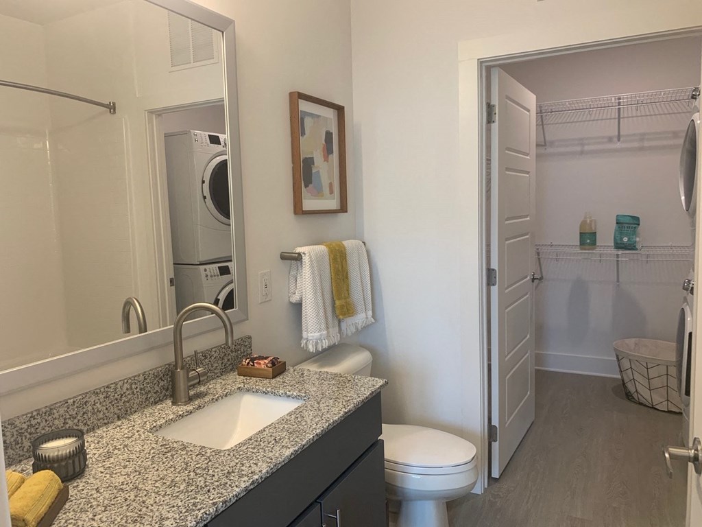 New bathroom with walk in closet and full size stack washer dryer at Link Apartments® Mixson, North Charleston, South Carolina