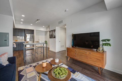 A modern living room with a wooden coffee table and a flat screen TV.