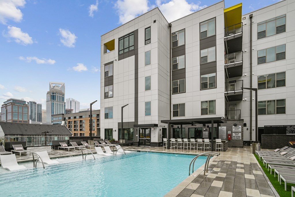 a swimming pool in front of a building a swimming pool in front of a building at Link Apartments® Mint Street, Charlotte