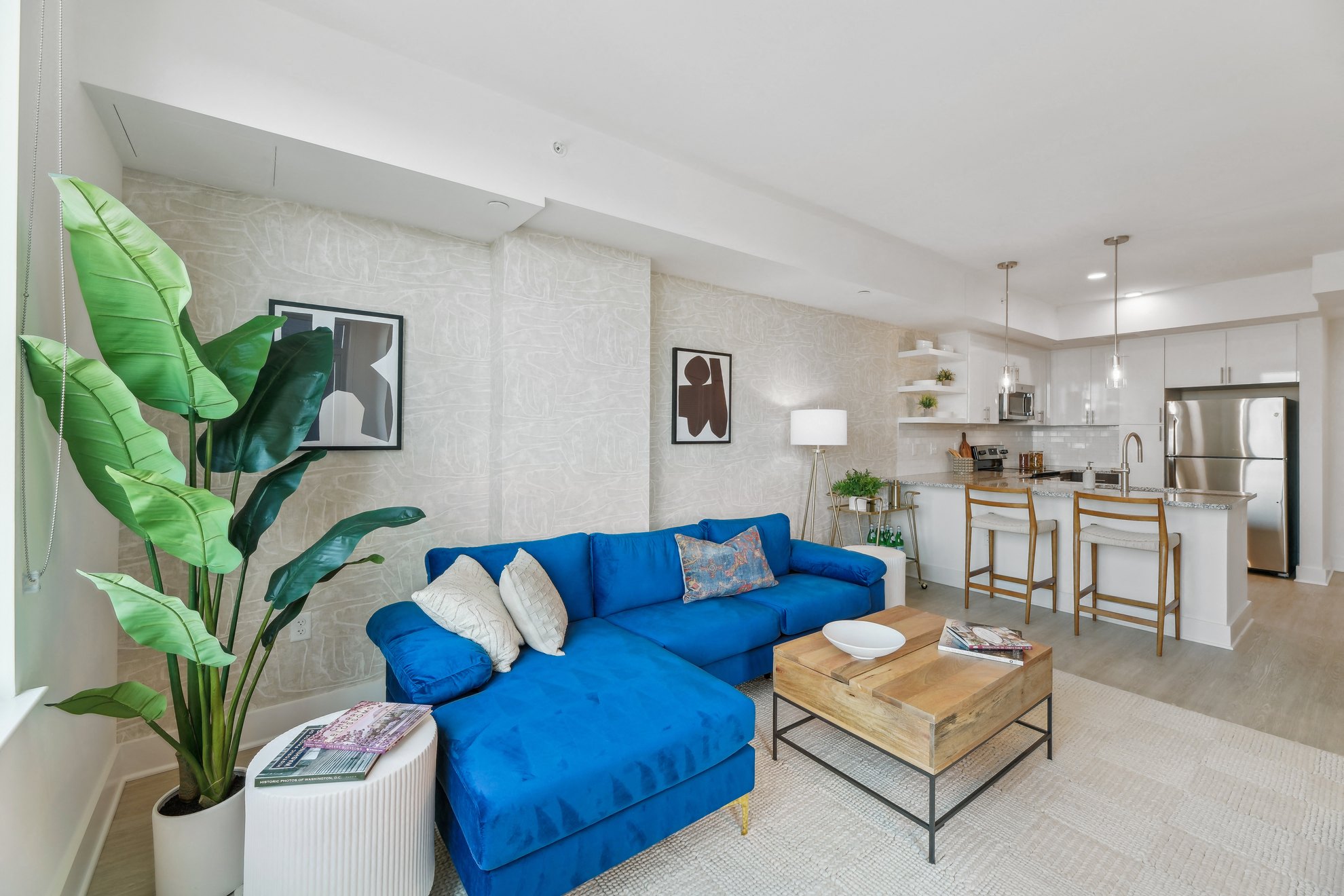 a living room with a blue couch and a table