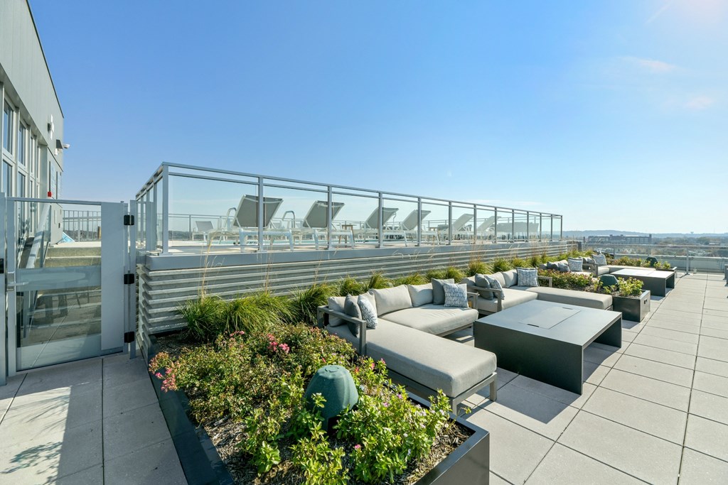 a terrace with couches and tables on a roof top  at Link Apartments® H Street, Washington, DC