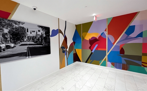 Large Muraled Walls with a black and white photo on the wall at Link Apartments 4th Street in Winston-Salem, NC