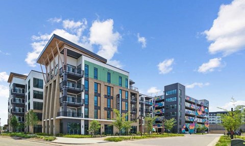 a new apartment building with a street in front of it