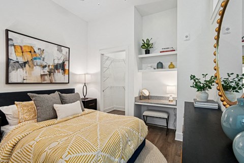 a bedroom with a bed and a mirror on the wall
