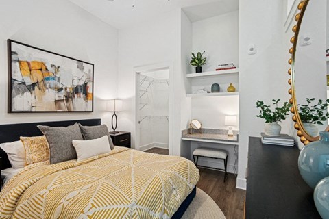 A bedroom with a bed, a desk, and a mirror. at Link Apartments® NoDa 36th Apartments, Charlotte